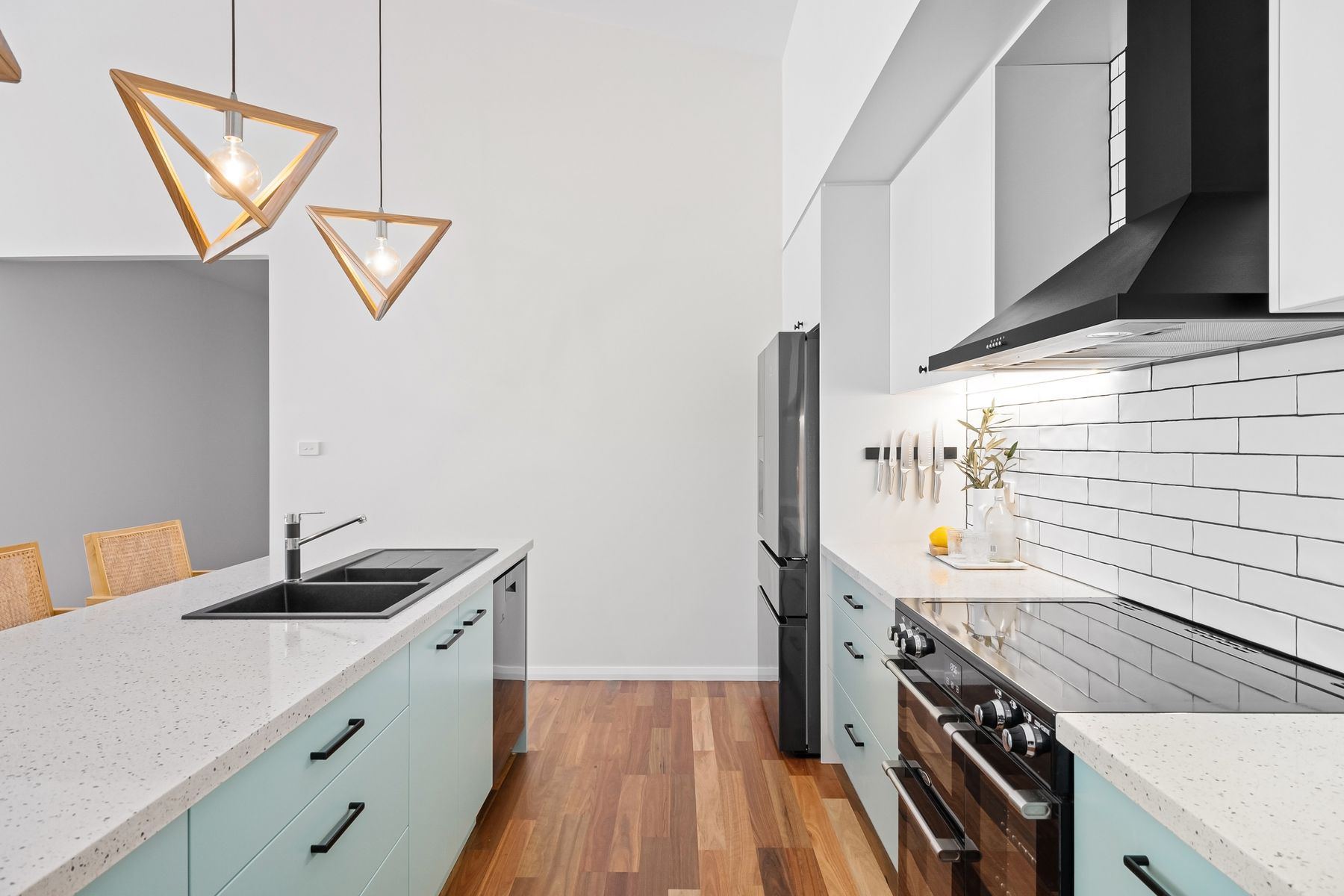 Bright kitchen with pale blue cabinets and white tile